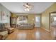 Comfortable living room with a large window letting in natural light, wood floors, and neutral tones at 2766 Privada Dr, The Villages, FL 32162