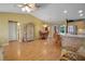 Open-concept living area flowing into dining and kitchen, featuring stylish furnishings and bright lighting at 2766 Privada Dr, The Villages, FL 32162