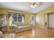 Comfortable living room with a large window letting in natural light, wood floors, and neutral tones at 2766 Privada Dr, The Villages, FL 32162