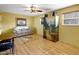 Inviting living room with wood floors, cozy seating, and decorative cabinet offers a comfortable space at 2766 Privada Dr, The Villages, FL 32162