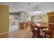 Open concept living space with a kitchen island, dining area, and comfortable seating area at 2766 Privada Dr, The Villages, FL 32162