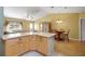 Open concept living space with a kitchen island, dining area, and comfortable seating area at 2766 Privada Dr, The Villages, FL 32162