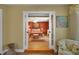 A view through a doorway to the main bedroom with a red accent wall at 2766 Privada Dr, The Villages, FL 32162
