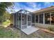 A screened porch with concrete patio in the backyard of a single Gathering home at 2766 Privada Dr, The Villages, FL 32162