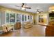 Cozy sun room with tile floor, large windows and comfortable seating provides tranquil backyard views at 2766 Privada Dr, The Villages, FL 32162