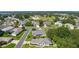 Serene community featuring beautifully landscaped homes, winding streets, and a glimpse of a distant lake at 2821 Mediterranean Loop, Tavares, FL 32778