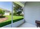View of the property's lush backyard from the screened patio, showcasing the manicured lawn and landscaping at 2821 Mediterranean Loop, Tavares, FL 32778