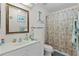 Bright bathroom featuring a shower, floral shower curtain, vanity, and nautical themed decor at 2821 Mediterranean Loop, Tavares, FL 32778