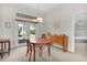 Cozy dining room with natural light, featuring a wood table, buffet, and access to backyard at 2821 Mediterranean Loop, Tavares, FL 32778