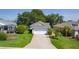 Well maintained home features a two car garage, mature landscaping, and a well manicured lawn at 2821 Mediterranean Loop, Tavares, FL 32778