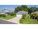 Charming single-story home with well-manicured lawn, mature landscaping, and a paved driveway at 2821 Mediterranean Loop, Tavares, FL 32778