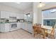 Well-lit kitchen features white cabinets, tile floors, modern appliances, and an adjacent breakfast nook at 2821 Mediterranean Loop, Tavares, FL 32778