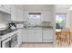 Bright kitchen with tile flooring, white cabinets, and a window above the sink offering natural light at 2821 Mediterranean Loop, Tavares, FL 32778