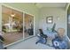 Enclosed patio featuring an exercise bike, table, chairs, and sliding glass doors to the living space at 2821 Mediterranean Loop, Tavares, FL 32778