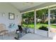 Relaxing screened patio with exercise bike, table and chairs, overlooking a lush backyard at 2821 Mediterranean Loop, Tavares, FL 32778