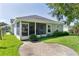 Back view of home with screened-in back porch area and grassy backyard at 2821 Mediterranean Loop, Tavares, FL 32778