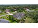 Aerial view of a home with a screened pool and lush tropical landscaping at 2904 Avalos Dr, The Villages, FL 32162