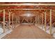Unfinished attic space showing beams, plywood flooring, insulation and possible additional storage at 2904 Avalos Dr, The Villages, FL 32162