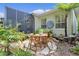 Stone patio with outdoor dining area and lush landscaping at 2904 Avalos Dr, The Villages, FL 32162