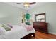 Inviting bedroom features natural light, plantation shutters and a wooden dresser at 2904 Avalos Dr, The Villages, FL 32162