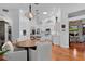 Open-concept kitchen showcasing white cabinets, stainless steel appliances, and a cozy breakfast nook at 2904 Avalos Dr, The Villages, FL 32162