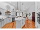 Open-concept kitchen with white cabinetry, stainless steel appliances, and view into the living space at 2904 Avalos Dr, The Villages, FL 32162