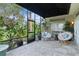 Cozy screened lanai furnished with comfortable seating and views of the lush, tropical landscaping at 2904 Avalos Dr, The Villages, FL 32162
