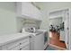 Functional laundry area with modern washer and dryer, plus ample storage cabinets at 2904 Avalos Dr, The Villages, FL 32162