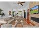 Bright and open living room featuring a stone fireplace and hardwood floors at 2904 Avalos Dr, The Villages, FL 32162