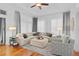 Bright living room with a plush sectional sofa, decorative pillows, and natural light streaming in through the windows at 2904 Avalos Dr, The Villages, FL 32162