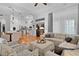 Spacious living room with modern decor, ample seating, and natural light filtering through large windows at 2904 Avalos Dr, The Villages, FL 32162
