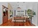 Bright living room with a stone fireplace, hardwood floors, and large windows for natural light at 2904 Avalos Dr, The Villages, FL 32162