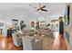 Inviting living room with hardwood floors, ceiling fan, neutral furnishings, and ample natural light at 2904 Avalos Dr, The Villages, FL 32162