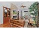Bright living room with a stone fireplace, hardwood floors, and large windows for natural light at 2904 Avalos Dr, The Villages, FL 32162