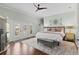 Bright main bedroom with wood floors, crown molding, french doors, and a comfortable king bed at 2904 Avalos Dr, The Villages, FL 32162
