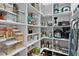 Organized pantry with custom shelving for ample storage of food items and small kitchen appliances at 2904 Avalos Dr, The Villages, FL 32162