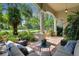 Covered patio with comfortable seating area and views of the meticulously landscaped yard at 2904 Avalos Dr, The Villages, FL 32162