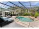 Relaxing screened-in pool area with lounge chairs and tropical landscaping at 2904 Avalos Dr, The Villages, FL 32162
