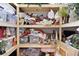 Storage shelves overflowing with holiday decorations, pillows, and other home goods at 2904 Avalos Dr, The Villages, FL 32162