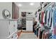 Walk-in closet featuring built-in shelving, drawers, and ample hanging space at 2904 Avalos Dr, The Villages, FL 32162