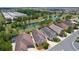 An aerial view of a community featuring a home with lush greenery, a serene lake, and various amenities at 2967 Thayer Ter, The Villages, FL 32163