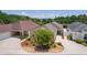 Stunning home with lush landscaping, a two-car garage and circular driveway at 2967 Thayer Ter, The Villages, FL 32163