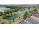 Aerial view showcasing a community with a scenic lake surrounded by lush landscaping at 2967 Thayer Ter, The Villages, FL 32163