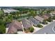 Expansive aerial showcasing a home with well-kept lawns, a serene pond, and community landscaping at 2967 Thayer Ter, The Villages, FL 32163