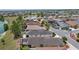 Scenic aerial view of a residential community with lush landscaping and a tranquil lake at 2967 Thayer Ter, The Villages, FL 32163