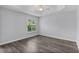 Cozy bedroom with tray ceiling, fan, and shuttered window offering natural light at 2967 Thayer Ter, The Villages, FL 32163