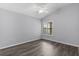 Bright bedroom featuring sleek wood floors, a modern ceiling fan, and a window at 2967 Thayer Ter, The Villages, FL 32163