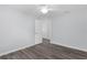 Well-lit bedroom with wood-look flooring leading to an open doorway at 2967 Thayer Ter, The Villages, FL 32163