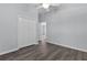 Spacious bedroom with dark wood floors and a double door closet at 2967 Thayer Ter, The Villages, FL 32163