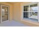 Inviting entryway featuring a glass door, neutral paint, and a large window with white shutters at 2967 Thayer Ter, The Villages, FL 32163